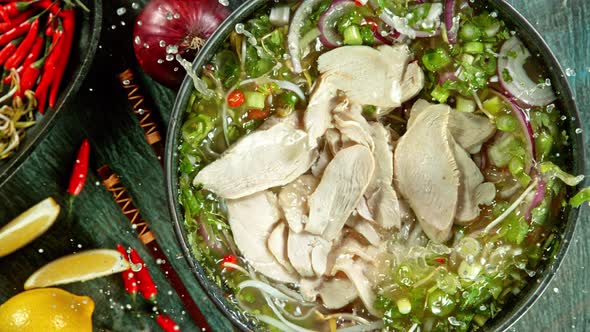 Super Slow Motion Shot of Chicken Slices Falling Into Pho Soup at 1000 Fps. alt
