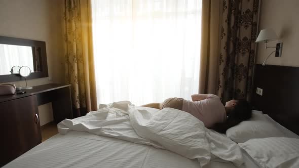 Woman Wakes Up and Stretches alt