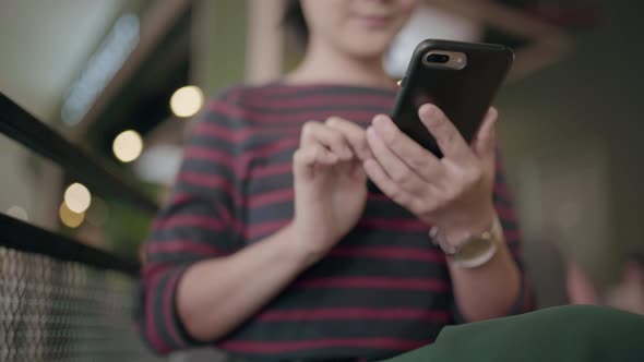 Close up shot asian woman using smartphone in cafe