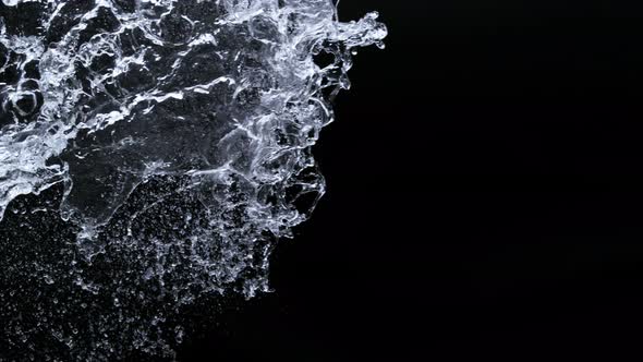 Super Slow Motion Shot of Side Water Splash Isolated on Black ...