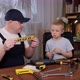 A Man in Overalls Teaches a Little Boy How to Use Various Tools for Repair - VideoHive Item for Sale