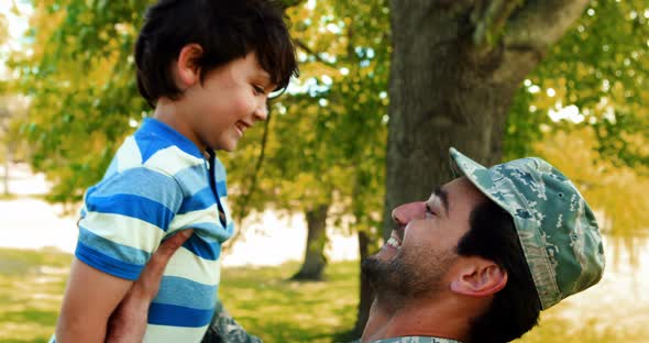 Army soldier lifting boy alt