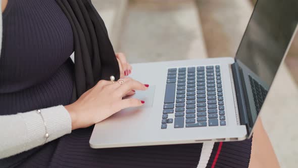Close Up Shot Of A Woman Typing On A Laptop Outside In Slowmotion alt