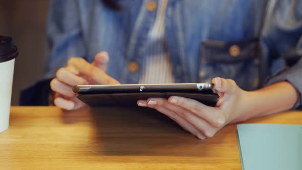 Young caucasian woman using digital tablet for her business.