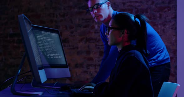 Woman and man working together at computers alt