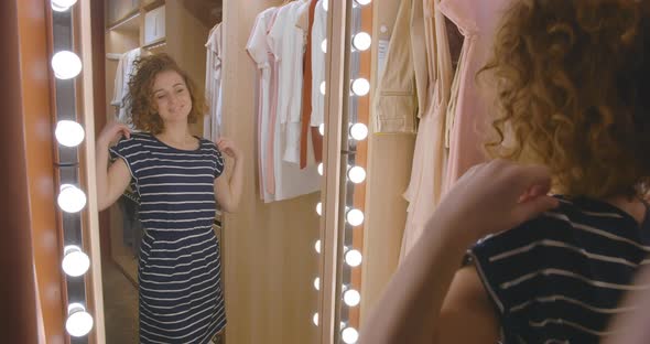 Beautiful Woman Looking in Mirror with Satisfaction and Smile alt