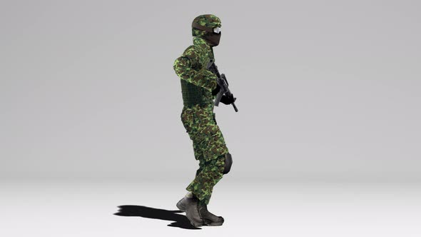 Soldier in camouflage walks with a weapon at the ready