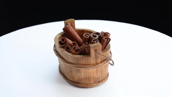 Cinnamon seeds in box on wooden table alt