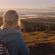 A Woman with a Backpack Behind Her Drink Ay and Admires the Beautiful Nature of Scandinavia - VideoHive Item for Sale
