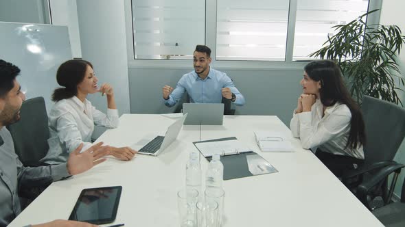 Excited Male Worker Sharing Good News with Happy Team Overjoyed Diverse Employees Group Screaming alt