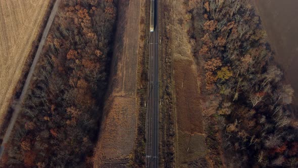 Aerial Drone View Flight Over Train Which Moves on Railroad on Autumn Sunny Day alt