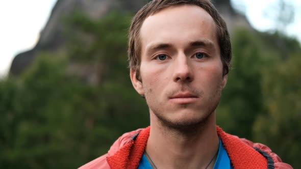 Slow Motion Portrait of a Young Male Hiker Looking at the Camera and Smiling