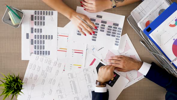 Corporate Financial Team Analyzing Charts and Diagrams with Market Sales alt