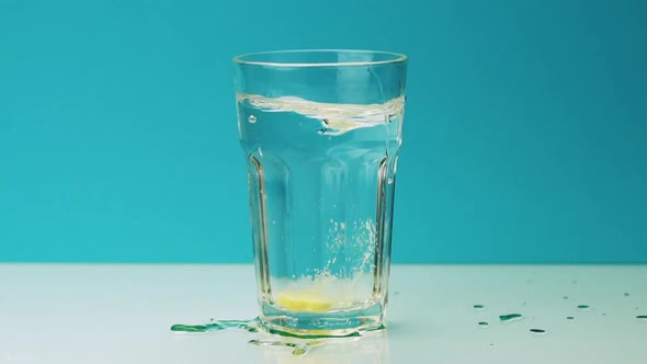 An Effervescent Pill Falls Into a Glass and Dissolves alt