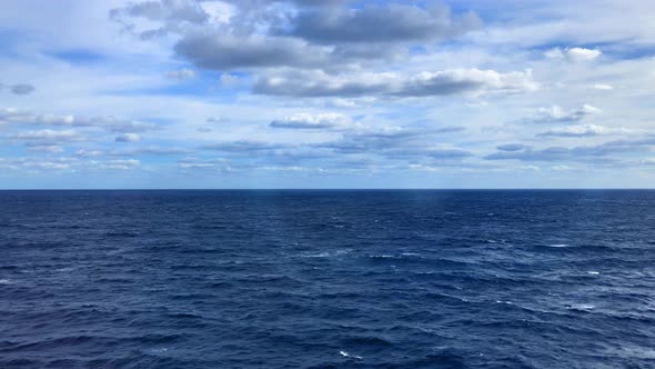 Ocean waves as the sun reflects on the frothy rolling waters alt