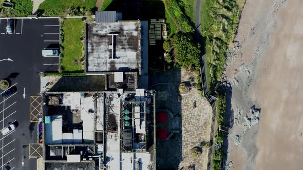 Top-down aerial view over the building rooftop and footpaths alt