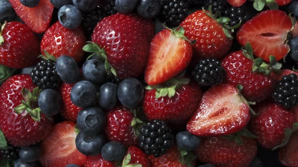 Wild Forest Berries on Black Background, Collection of Strawberry, Blueberry and Blackberry. alt