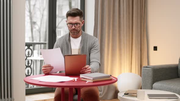 Man Working with Documents at Home alt