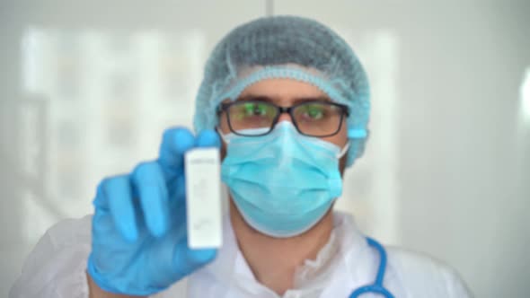 Doctor in Protective Mask Holds Rapid Antigen Test for Covid19 in Laboratory