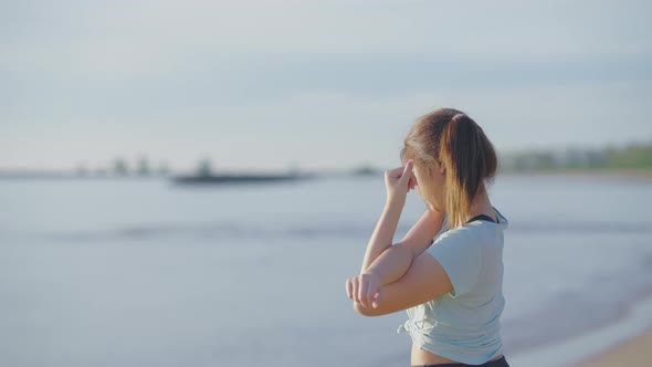 Asian cute girl She was walking and stretching before her morning run at the beach.