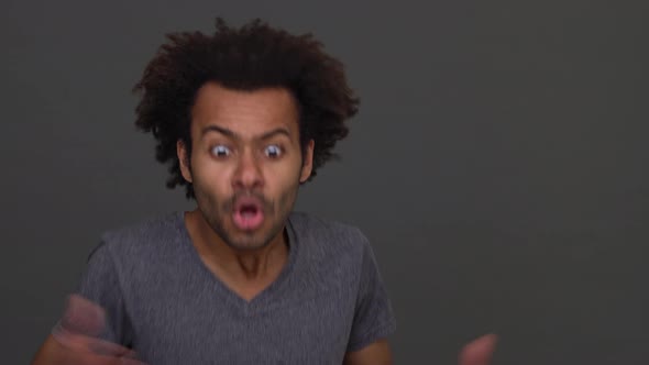 African American Young Man Angrily Gesturing and Shouting Isolated on Charcoal Background alt