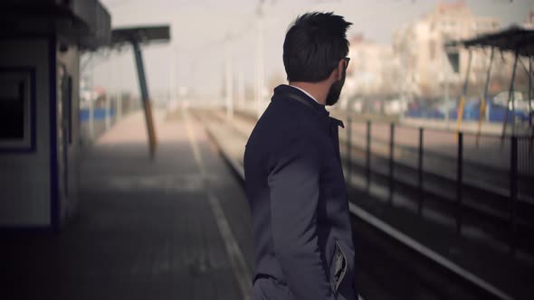 Businessman Commute To Work Sitting On Railway Train Station Platform. City Tourist Transportation. alt