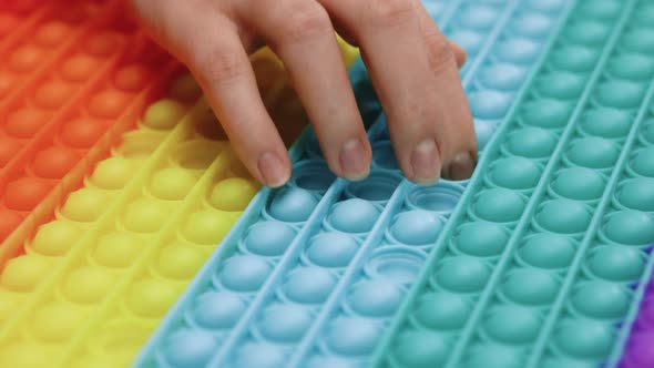 Finger Presses Bubbles on Children's Popular Anti-stress Toy Pop it
