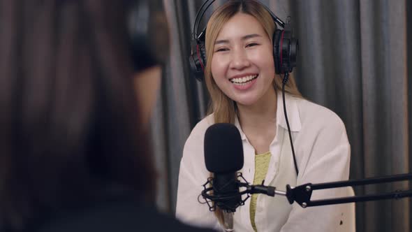 Two Young Asian women influencers' conversations while recording podcasts.