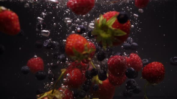 Strawberries, Blueberries, Raspberries Washes In Flowing Water