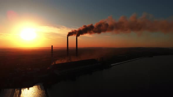 Aerial Drone View: High Chimney Pipes with dirt smoke from Coal Power Plant.