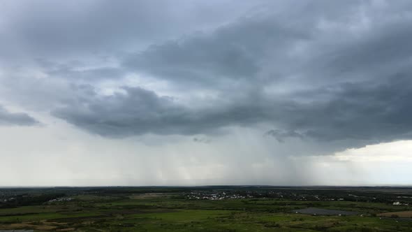 Landscape of Dark Clouds Forming on Stormy Sky During Thunderstorm Over Rural Area alt