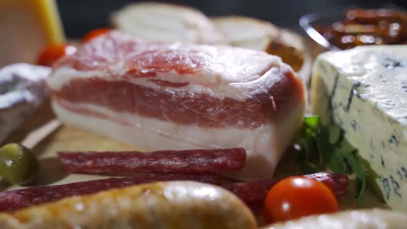 Various Types of Cheese and Sausages with Vegetables Closeup alt
