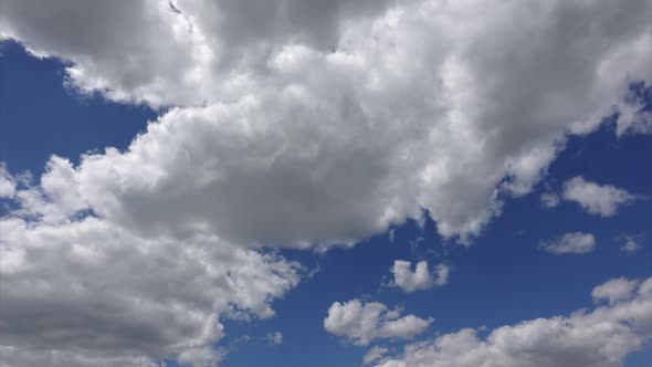 White clouds at blue sky background, timelapse. Beautiful heaven