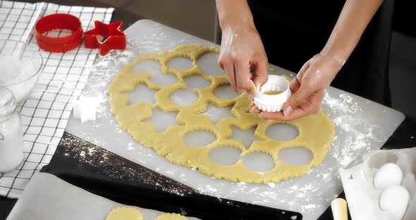 Woman Puts Shortbread Cookies on a Baking Tray alt