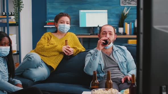 Multiethnic Friends Looking at Television Laughing alt