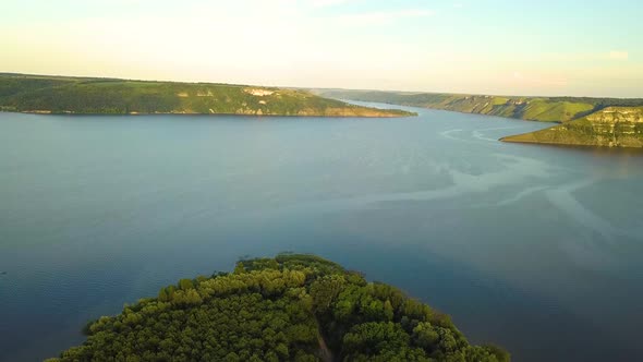 Aerial view of wide Dnister river and distant rocky hills in Bakota area, part of the National park  alt