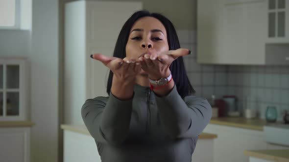 African Woman Sending Kiss To Camera alt