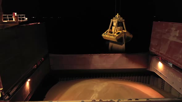 Nighttime Closeup of Cargo Bulker Anchored in Seaport During Loading Grain on Ship alt