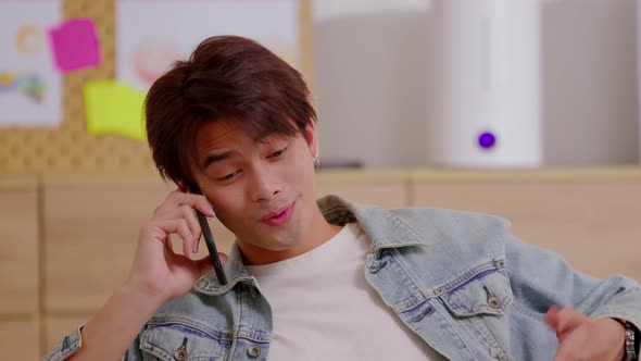 Closeup Asian smiling man talking mobile phone. Talking on smart phone with client and discussing ne alt