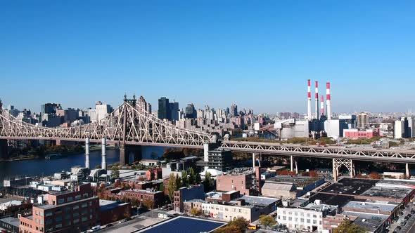 Vehicles Driving At Queensboro Bridge With Ravenswood Generating Station Smoke Stacks In The Backgro alt