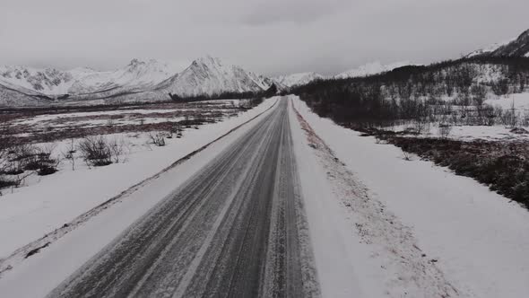 Frozen road in an isolated valley filmed with drone