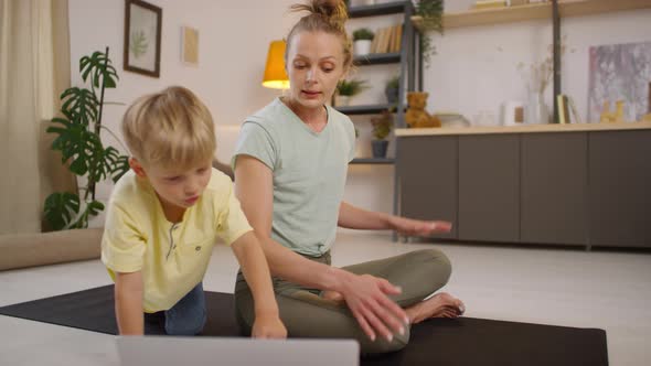 Young Woman with Kid Teaching Online Yoga Class alt