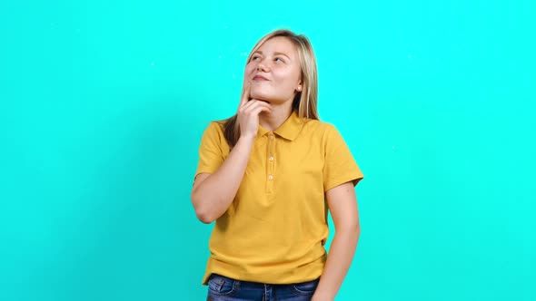 The Cheerful Young Woman Thinks of Positive Ideas and Smiles. alt