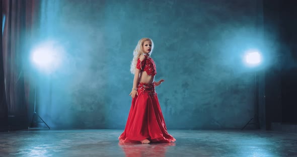Beautiful Blonde Dances Oriental Dance in a Chic Costume with Stones. Eastern Body Movements