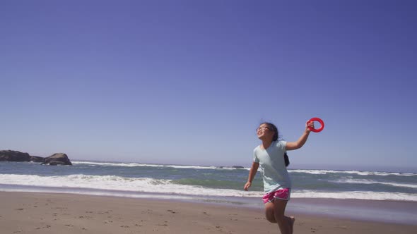 Young girl flying kite at beach
