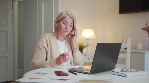Grandmother Puts on Wireless Headphones and Turns on Music From a Laptop