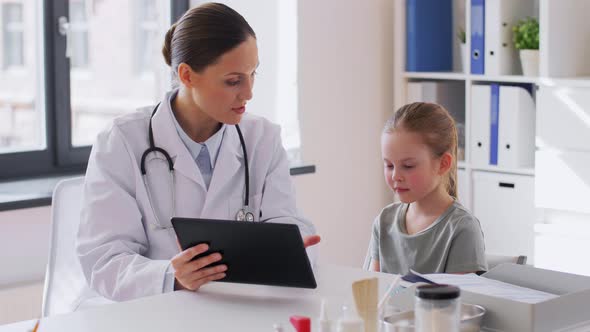 Doctor Showing Tablet Pc to Little Girl at Clinic
