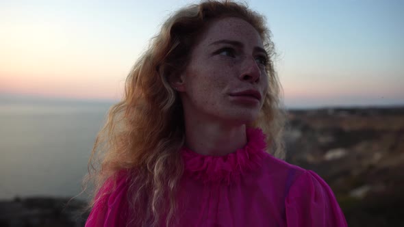 Close Up Shot of Beautiful Young Caucasian Woman with Curly Blond Hair and Freckles Looking at alt