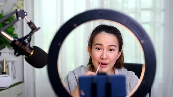 Asian Woman blogger or vlogger working online for beauty and makeup. Social media