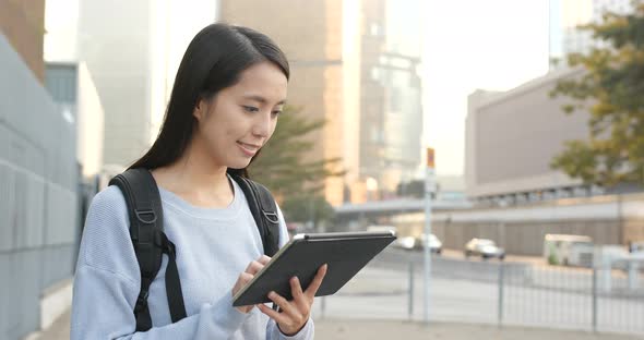Woman use of digital tablet computer at outdoor alt